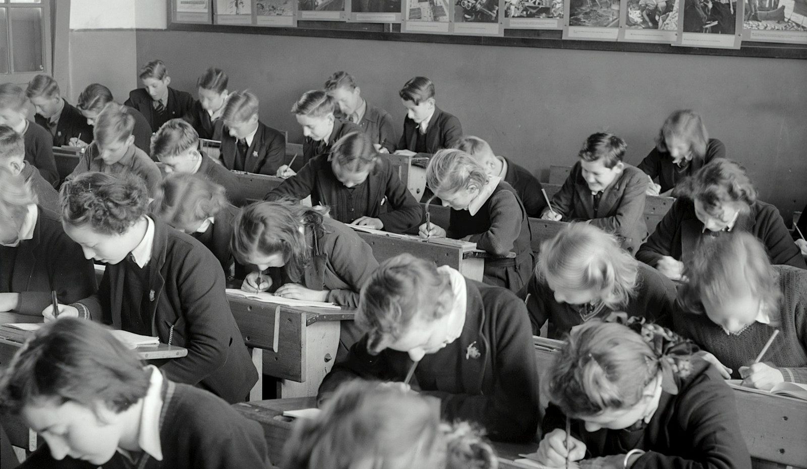 grayscale photo of people sitting on chair